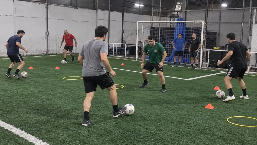 Imagen ilustrativa de jugadores amateurs adultos entrenando fútbol, generada con IA